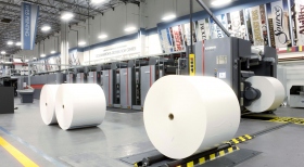The 121-ton web press uses 10-mile-long paper rolls and can print 55,000 pages per hour, in more than a dozen languages.